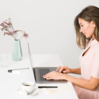 Woman In Pink Dress Using Laptop Computer 1586973