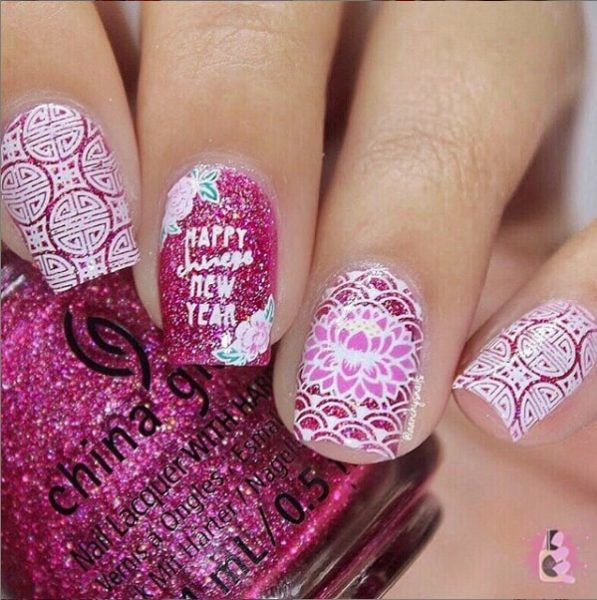 @aanchysnails strays from the red and gold with this pink and white set decorated with lotus flowers