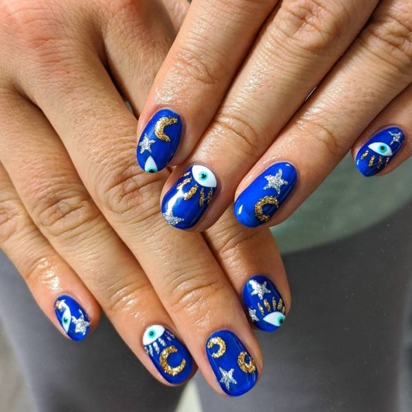 @paintedbycole created striking starry blue nail art look