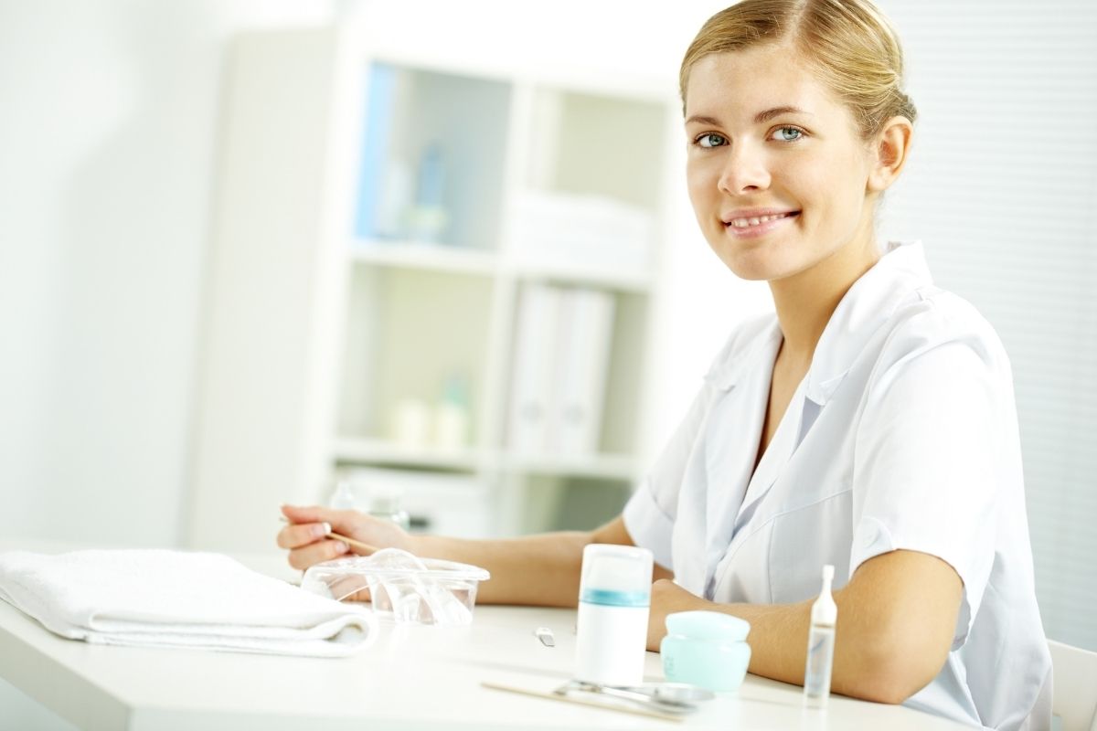 nail tech at desk