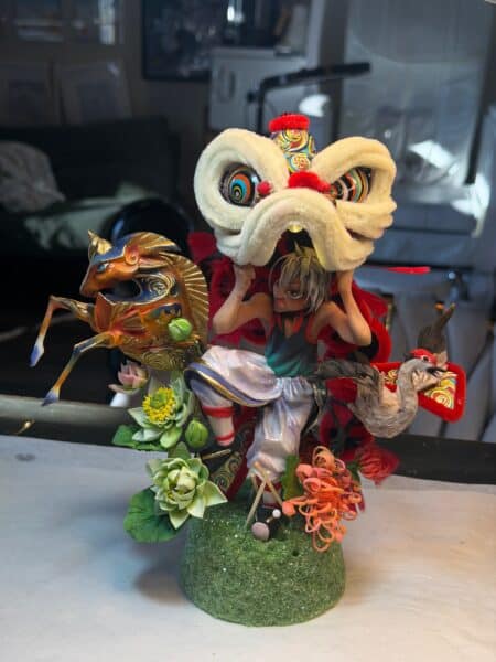 Colourful lion dance sculpture with horse and crane figures
