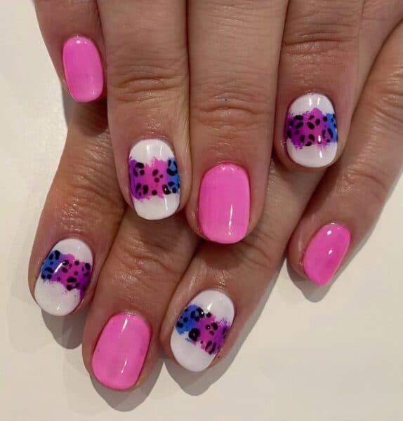 Pink and white nails with colourful leopard print accents