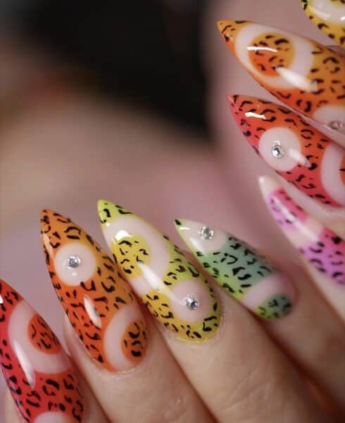 Colourful leopard-print stiletto nails with rhinestone accents