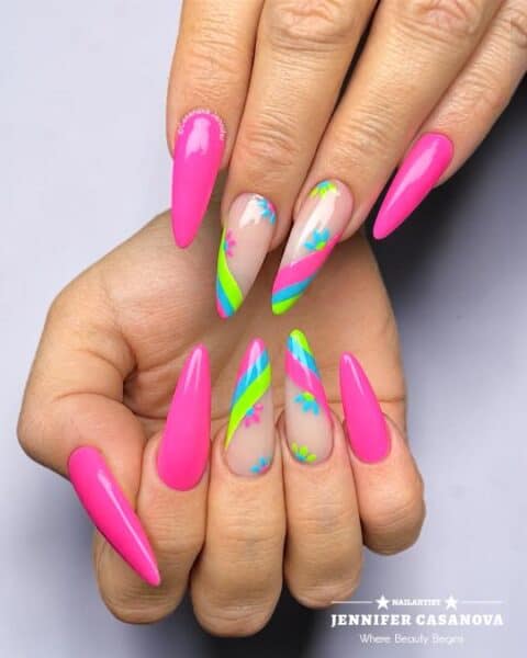 Hands with neon pink and rainbow striped nail art