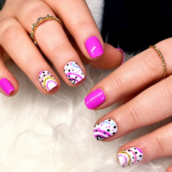 Hands with vibrant pink and patterned nail art
