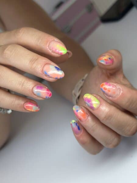 Hands displaying colourful neon abstract nail art