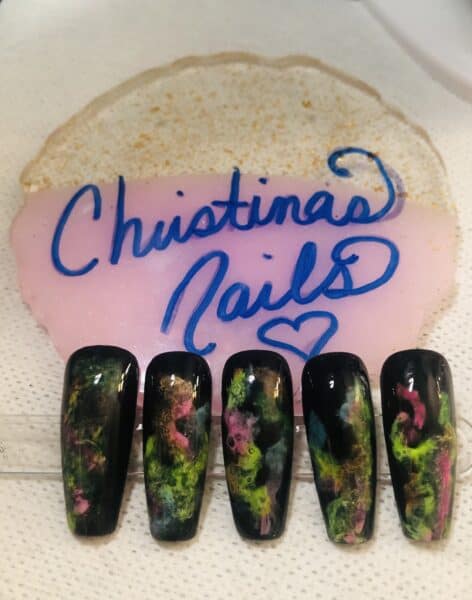 Black nail tips with colourful abstract galaxy-style designs
