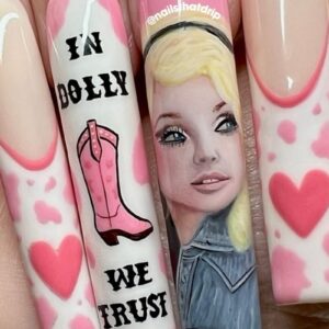 Barbie-inspired pink nail art with portrait and cowboy boot