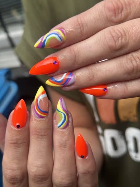 Close-up of colourful swirled acrylic nail art