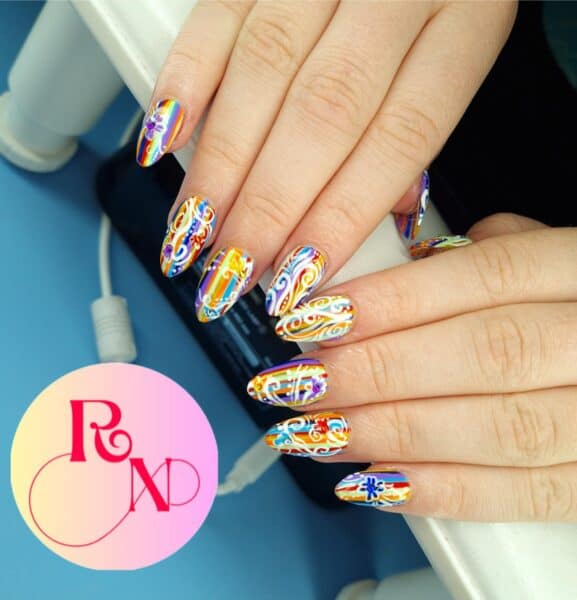 Hands with colourful rainbow floral nail art