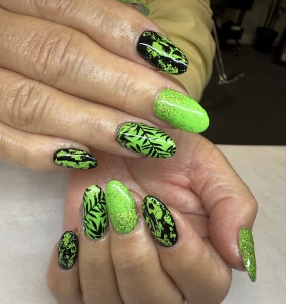 Neon green and black leafy patterned manicure