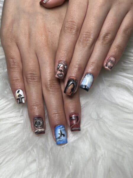 Hands with horror-themed illustrated acrylic nail art