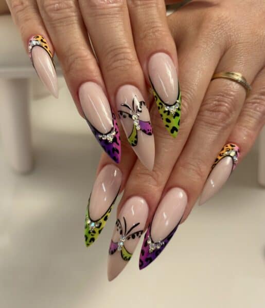 Colourful leopard print stiletto nails with rhinestone embellishments