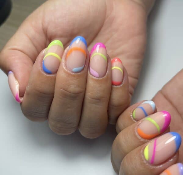Glossy nude nails with vibrant neon curves and French tips