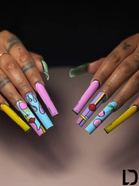 Colourful illustrated long nails on tattooed hands