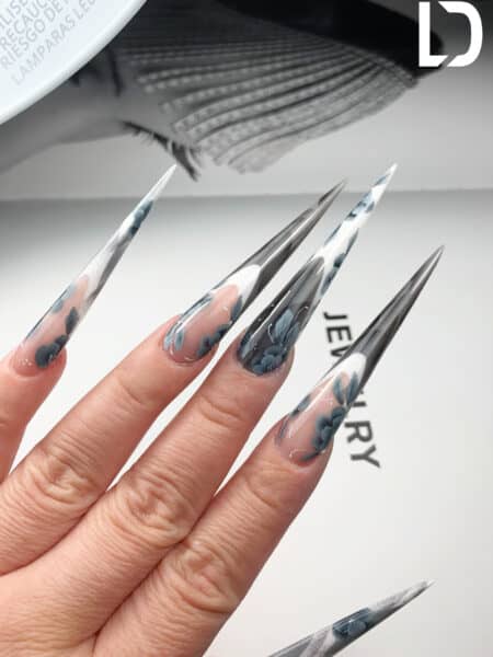 Long stiletto nails with blue floral transparent designs