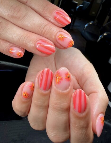 Pink nails with red stripes and orange flower details