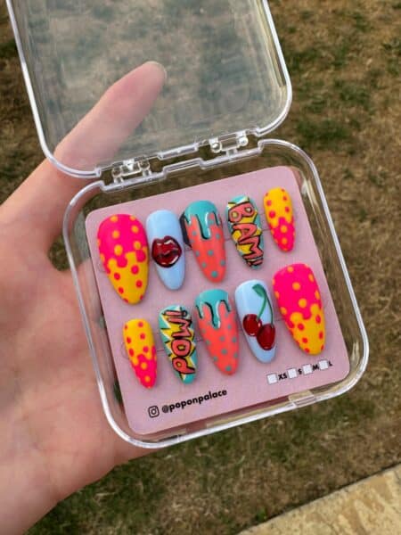 Colourful pop art false nails in storage case