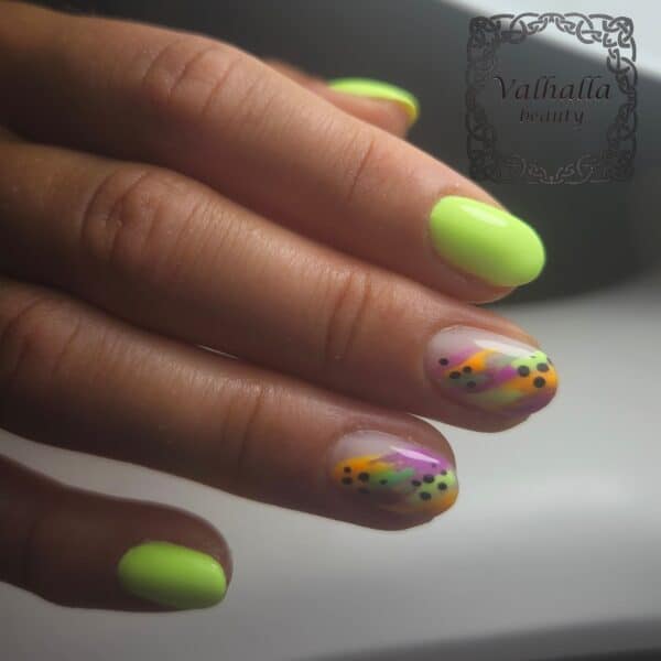 Neon green and colourful patterned manicure
