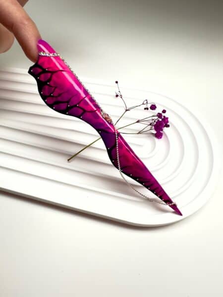 Pink stiletto nail art with black floral design