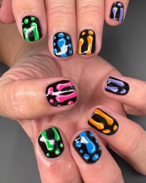 Black nails with colourful abstract drip patterns