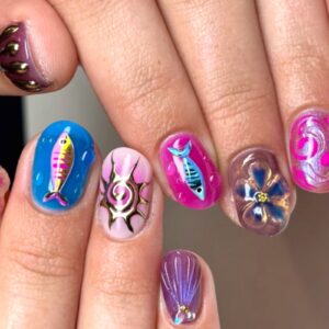 Colourful 3D nail art with fish, flowers and swirls