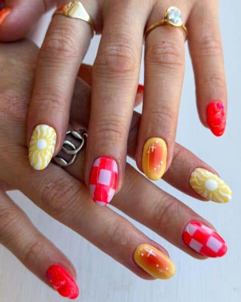 Hands displaying colourful summer-themed nail art