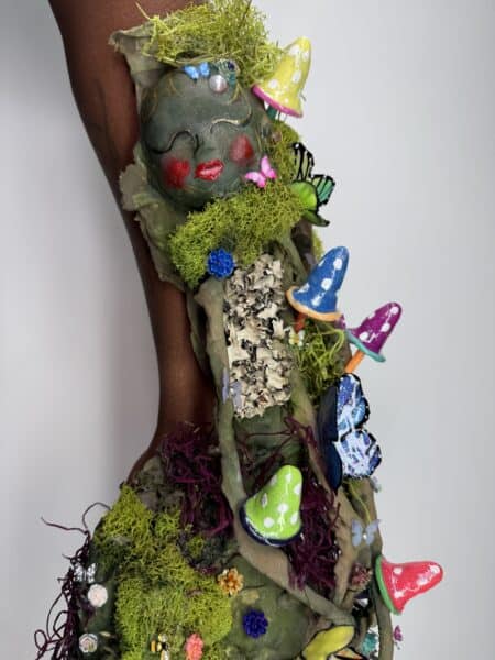 Intricate botanical nail art with moss and colourful flowers