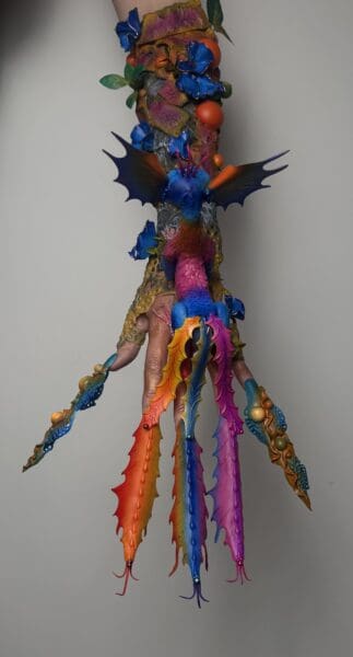Colourful fantasy body art with floral and winged designs