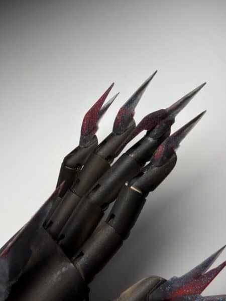 Close-up of black and red glitter acrylic nails