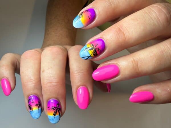 Tropical sunset nail art with palm tree silhouettes