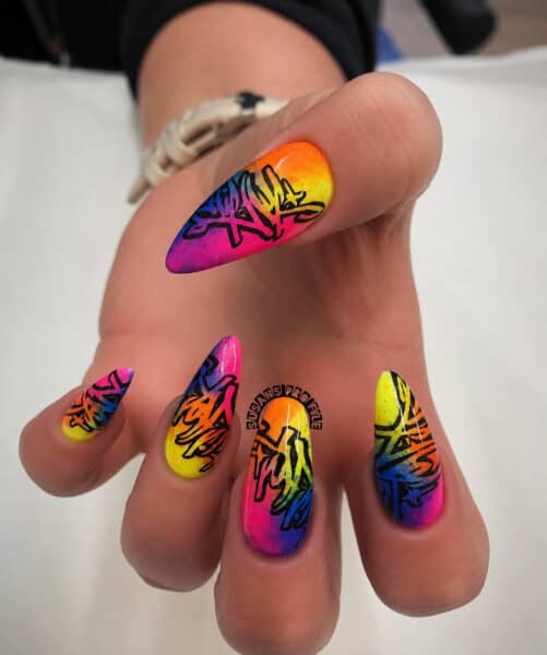 Rainbow graffiti nail art on long pointed nails