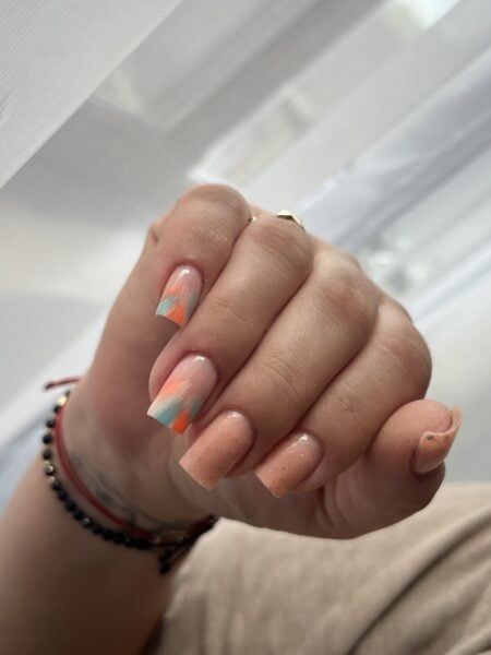 Close-up of colourful patterned acrylic nails