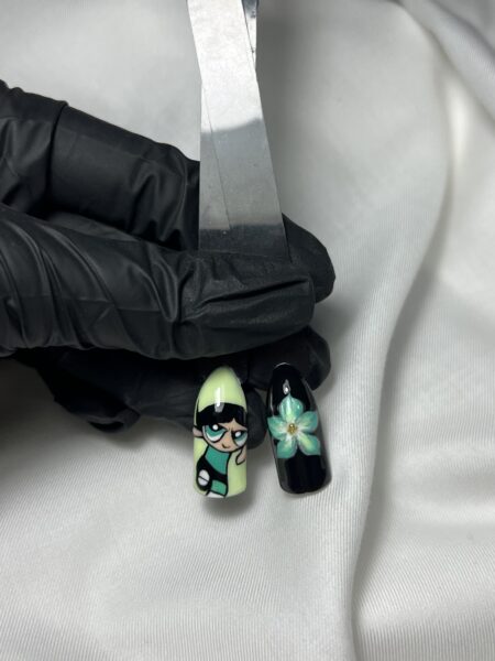 Black and green illustrated nail art