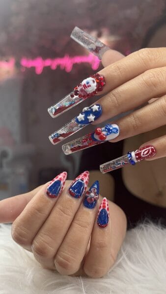Long embellished red, white and blue acrylic nail art