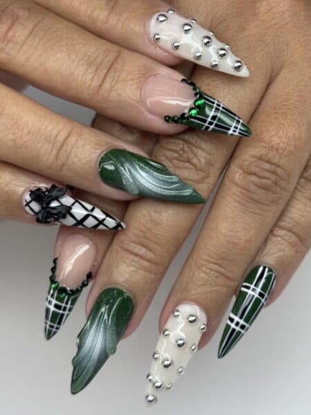 Green and white stiletto nails with studs and bows