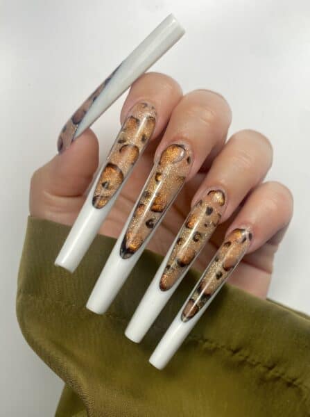 Long white nails with glittering amber tortoiseshell inlays