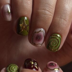 Close-up of glossy green and burgundy swirl nail art