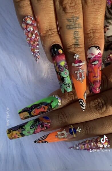 Colourful extra-long nails with portraits, rhinestones and orange accents