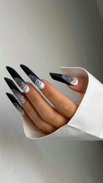 Black stiletto nails with grey floral nail art