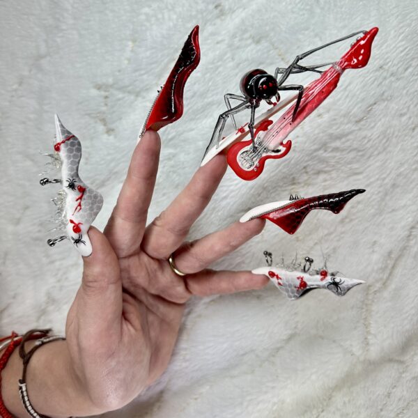 Red, black and white spider-themed sculpted stiletto nails