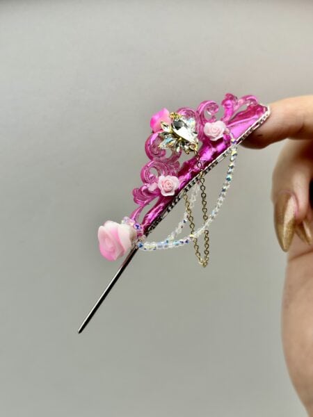 Pink floral nail art with crystal butterfly and chains