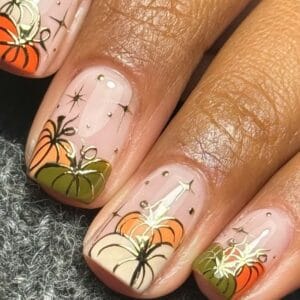 Autumn-coloured floral nail art with gold accents