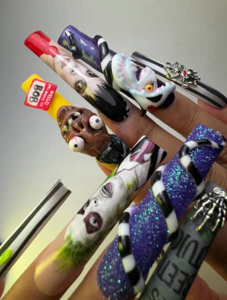 Long horror-themed nail art with sculpted monsters and glitter