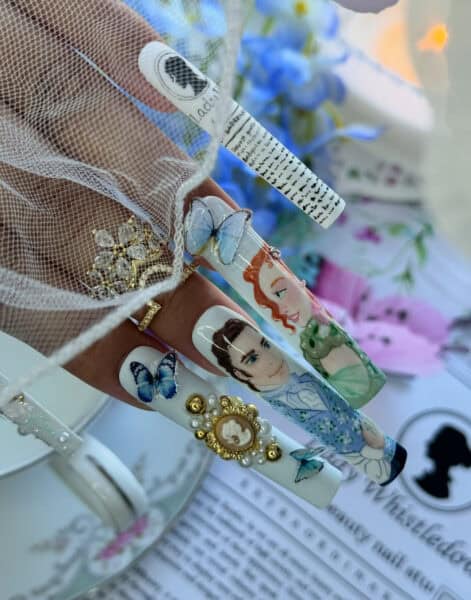 Elaborate Regency-inspired nail art with portraits and butterflies