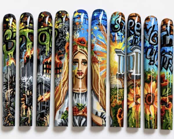 Colourful graffiti-style painted artificial nails with portrait and flowers