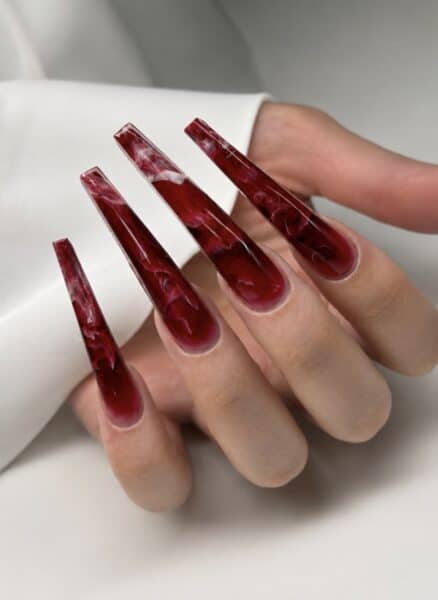 Deep red marble-effect long square acrylic nails