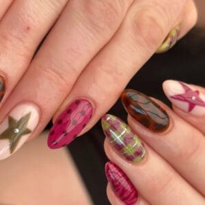 Hands displaying colourful abstract patterned nail art