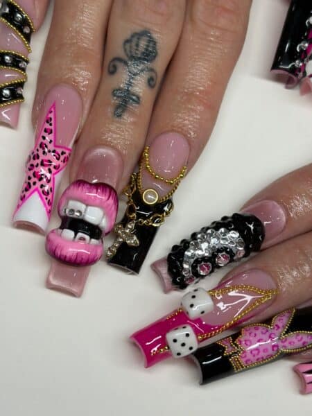 Pink and black 3D manicured nails with dice and lips