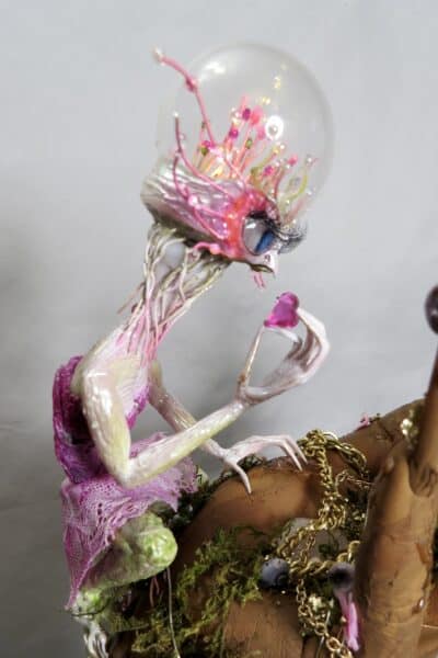 Colourful translucent fantasy creature sculpture with pink tendrils